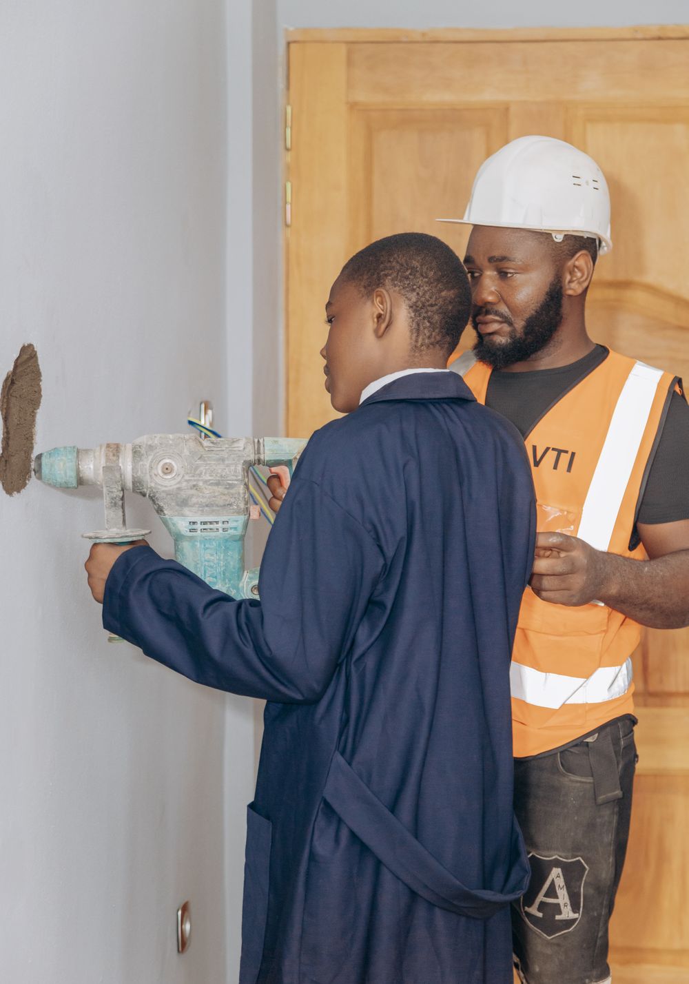 A student using a power drill