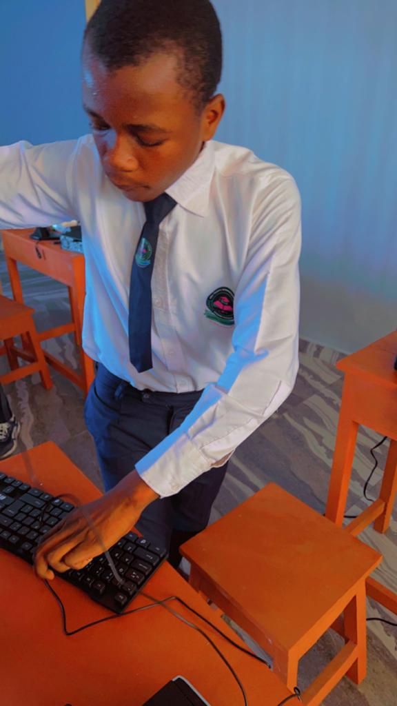A student typing at a computer